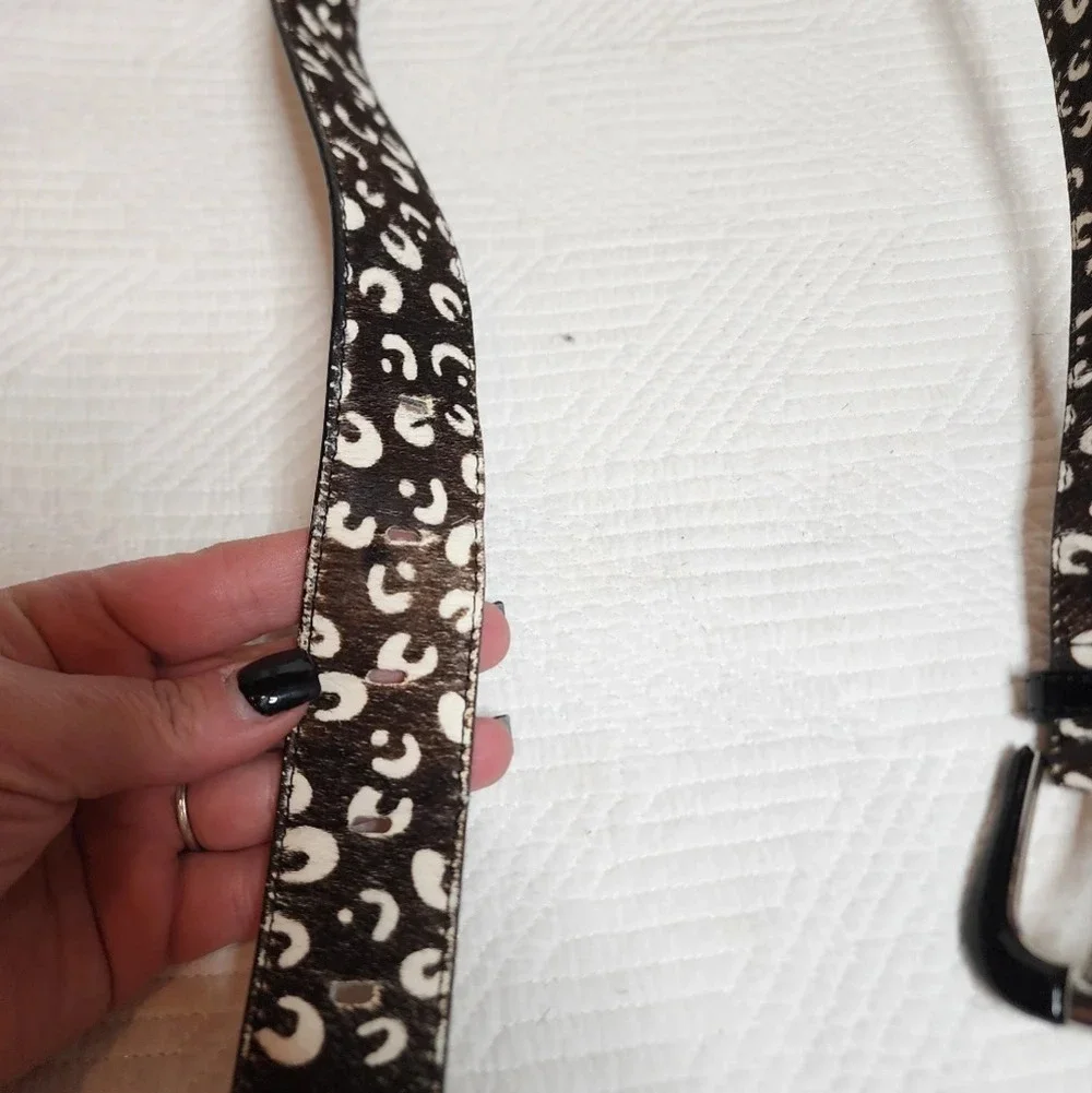 100% calf hair leather‎ dark brown, white spotted belt.